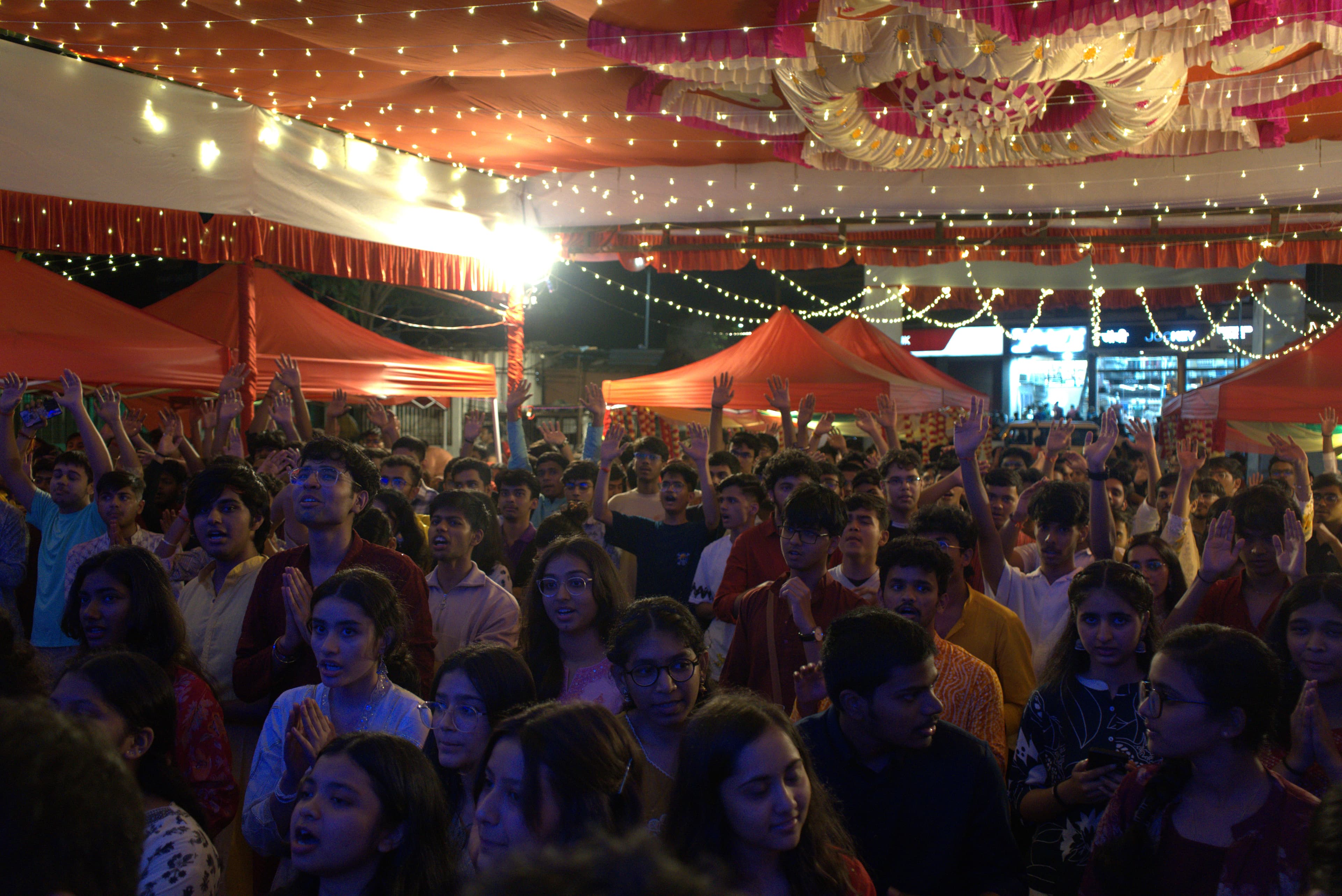 NST Charaja crowd under the pandal lights